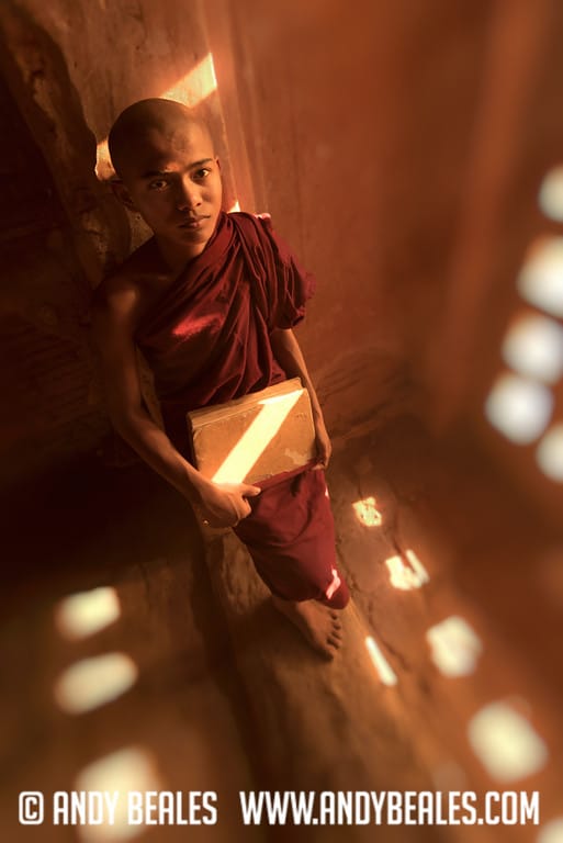 14 Year old monk in Burma waits by the wall