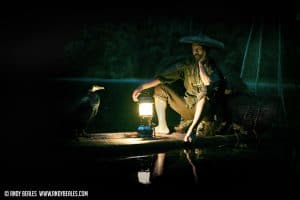 A cormorant fisherman night fishing in Guilin China by lamp light